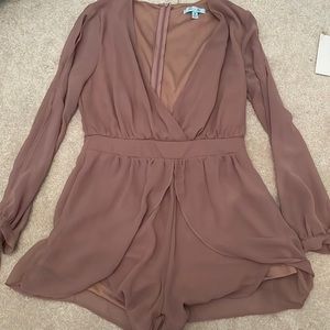 dark purple-ish romper, slits in the arms, low v neck.
